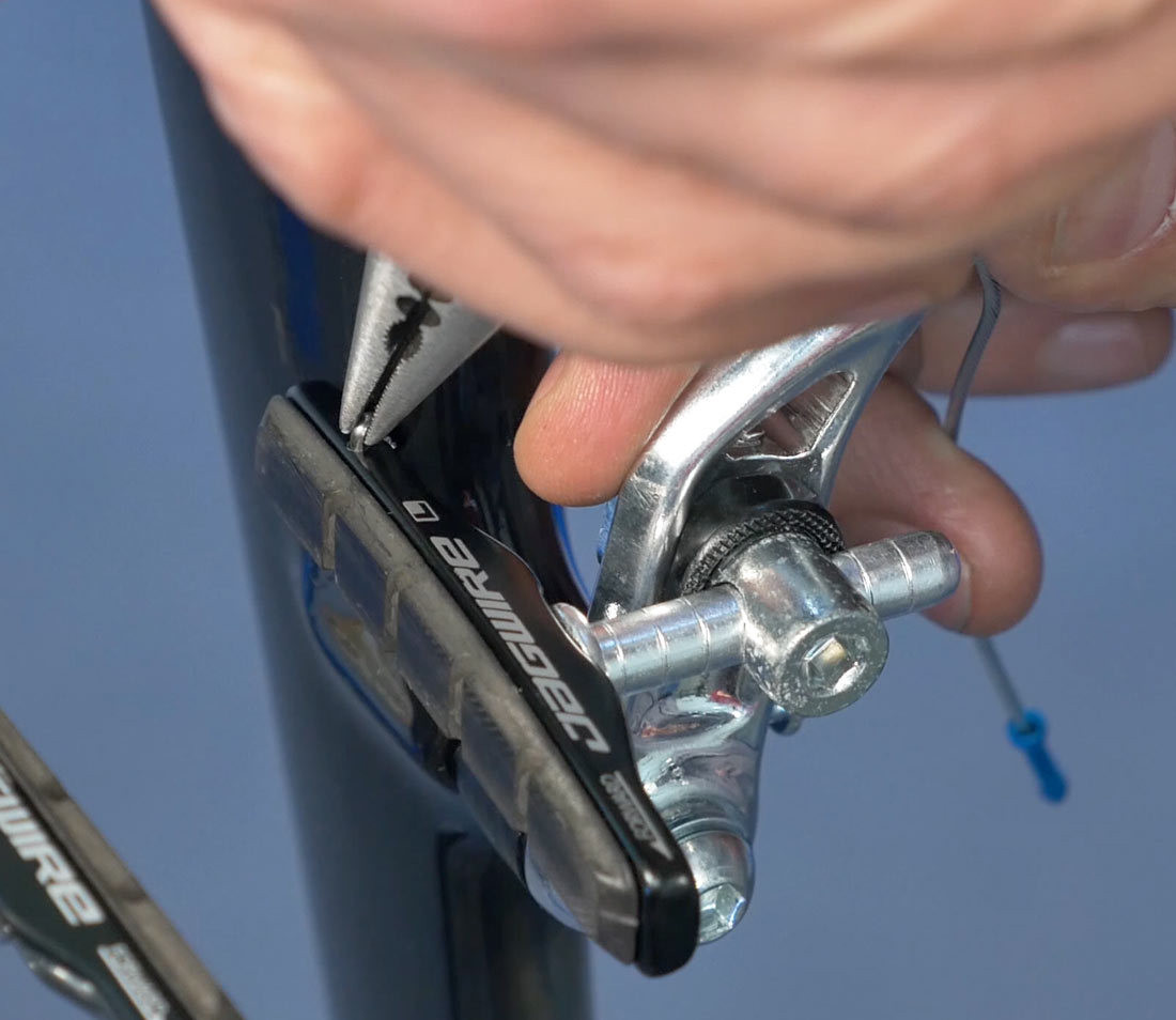 Remove pad retaining clip before pushing pad from holder