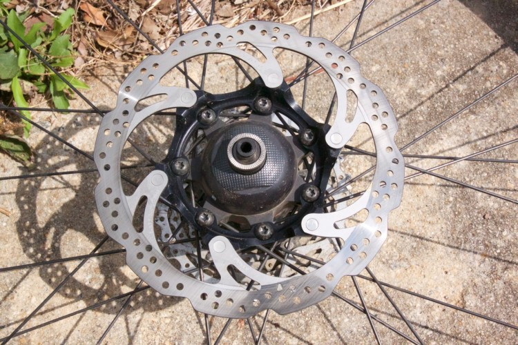 Close-up of a mountain bike's handlebars with ergonomic grips and a GPS device mounted