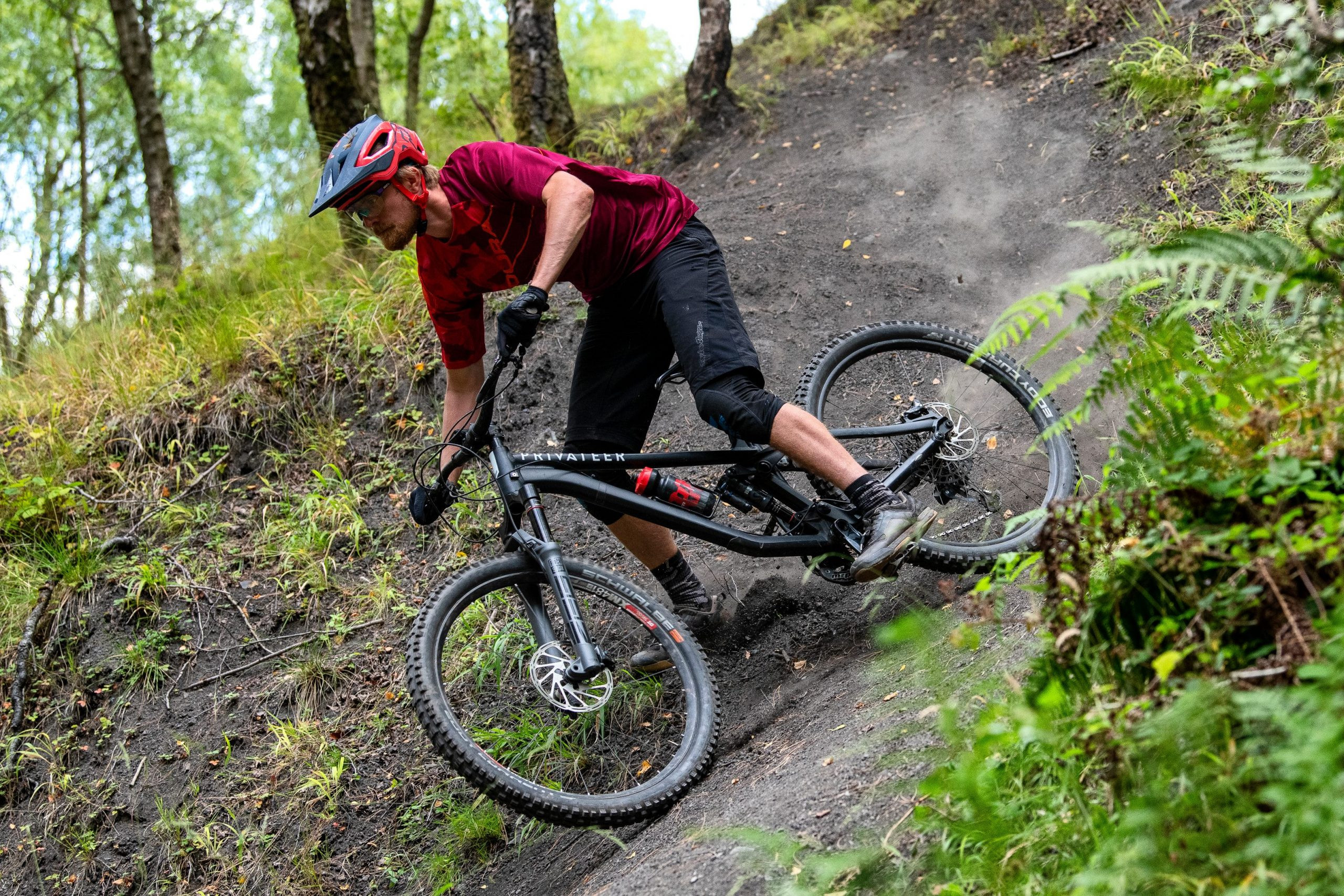 A rider on a BMW adventure bike navigates a rocky trail, showcasing its rugged capabilities