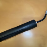 Photo of a black air pump on a wooden background
