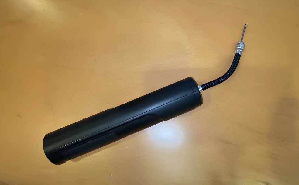 Photo of a black air pump on a wooden background