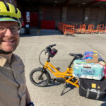 E-bike rider with groceries from Costco, indicating the utility of e-bikes