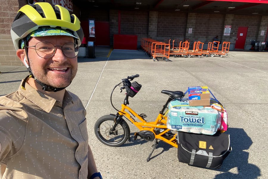 E-bike rider with groceries from Costco, indicating the utility of e-bikes