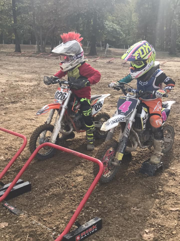 Two peewee racers lined up at a race start, showcasing the excitement of youth motocross