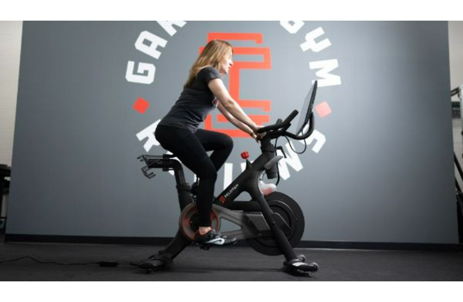 Woman riding peloton bike