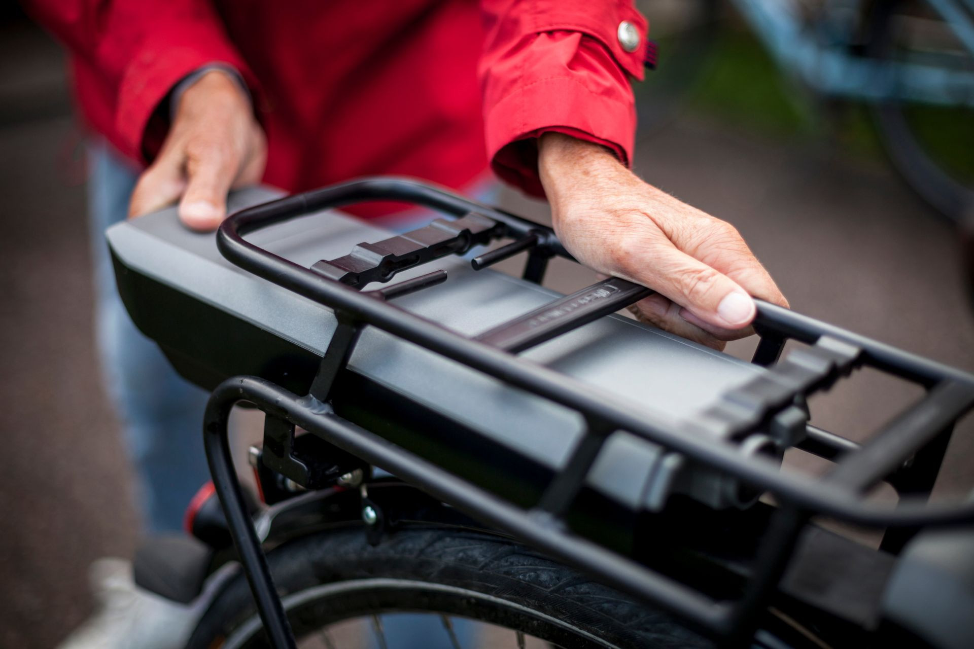 Cyclist removing the battery on their electric bike to clean electrical contacts